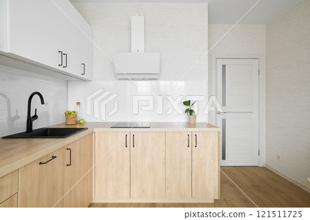 Explore the beautiful blend of rich wood tones in a modern minimalist kitchen design 121511725