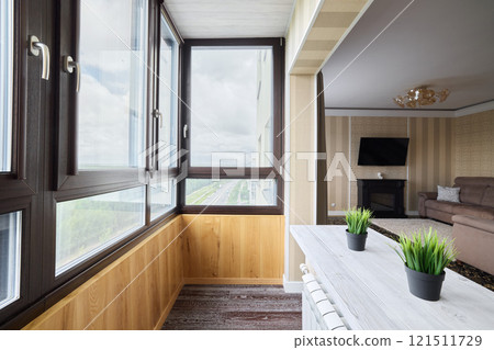 A stylish modern sunroom in a contemporary apartment setting exuding comfort and chic design 121511729