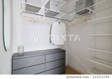 Embracing Minimalist Closet Organization Featuring Neutral Tones and a Modern Design Aesthetic Embracing Minimalist Closet Organization Featuring Neutral Tones and a Modern Design Aesthetic 121511744