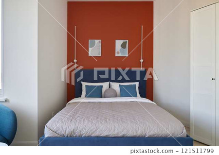 A stylish bedroom interior with colorful accents, creating an inviting and comfortable ambiance 121511799