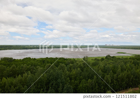 Aerial View of a Beautiful and Serene River Landscape Surrounded by Lush Greenery and Nature 121511802