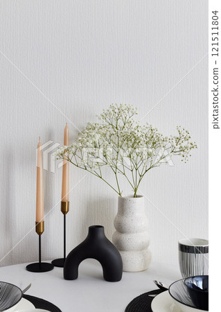 An Elegant Minimalist Table Setting Graced with Fresh Flowers and Beautiful Candles An Elegant Minimalist Table Setting Graced with Fresh Flowers and Beautiful Candles 121511804