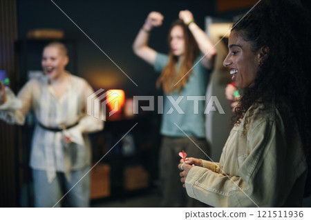 Young People Playing Darts At Home 121511936