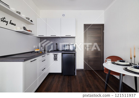 This is a Modern Kitchen Interior that features a Sleek Design along with a Minimalist Aesthetic 121511937