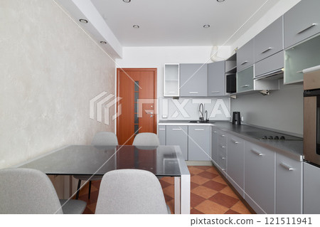 This modern kitchen showcases a stunning dining area full of elegance and sophistication This modern kitchen showcases a stunning dining area full of elegance and sophistication 121511941