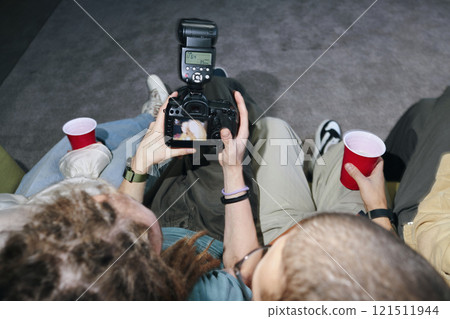 Friends Watching Photos On Camera 121511944