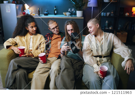 Friends Watching Photos On Camera 121511963