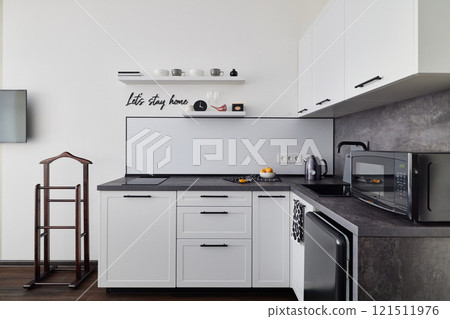 Contemporary Kitchen Interior Featuring a Minimalist Design with Highly Functional Appliances 121511976