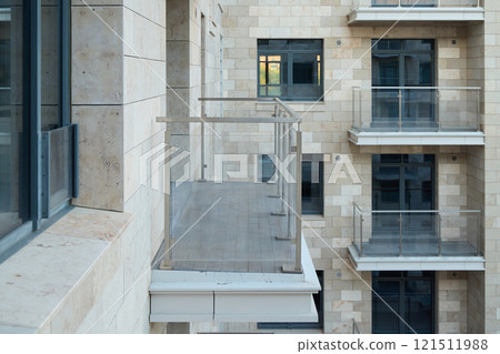 A Sleek and Modern Apartment Balcony Featuring Elegant Glass Railings for Safety and Style 121511988