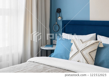 A Modern Cozy Bedroom Featuring Stylish Decor That Incorporates Soothing Colors and Elements 121512023