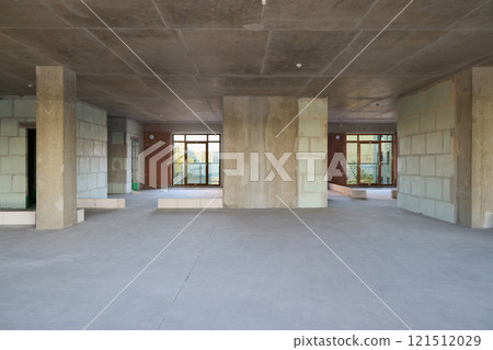Spacious modern interior with stylish concrete finishes and large windows for natural light Spacious modern interior with stylish concrete finishes and large windows for natural light 121512029