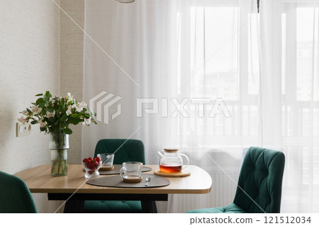 A Modern Dining Space Featuring Refreshing Tea and Beautifully Arranged Fresh Flowers 121512034