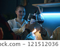 Friends Celebrating With Glasses Of Red Wine 121512036