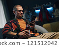 Man Surfing The Net In Smartphone At Party 121512042
