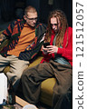 Guys Using Smartphone At Party 121512057