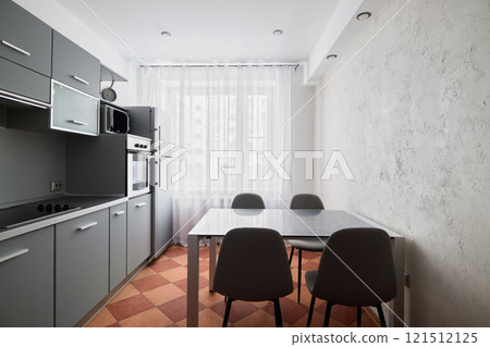 A Bright Modern Kitchen Interior Featuring a Dining Area Bathed in Beautiful Natural Light 121512125
