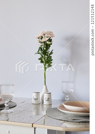 An Elegant Table Setting Featuring a Beautiful Floral Centerpiece to Enhance Dining Experience 121512148