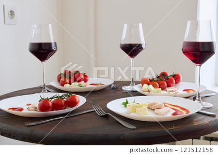 A Beautifully Elegant Dinner Table Setting Complete with Fine Wine and Gourmet Dishes 121512158