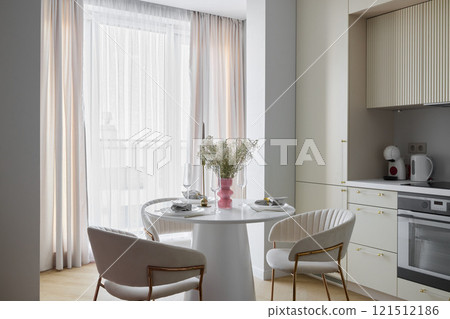 Modern Kitchen Interior with a Stylish and Inviting Dining Area for Family Gatherings 121512186