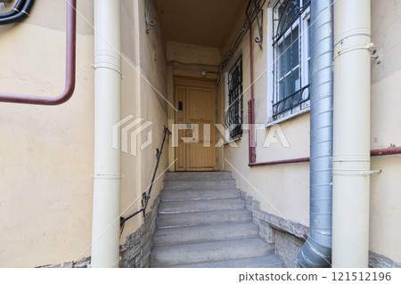 An inviting entrance and stairway lead charmingly to the residential door, enhancing access An inviting entrance and stairway lead charmingly to the residential door, enhancing access 121512196