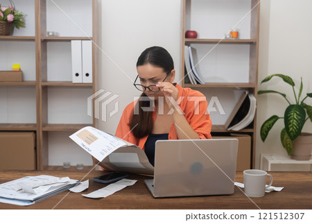 worried lady, homebound, gazes at a utility bill, her mind preoccupied with mortgage payment concerns and mounting debt worried lady, homebound, gazes at a utility bill, her mind preoccupied with mortgage payment concerns and mounting debt 121512307