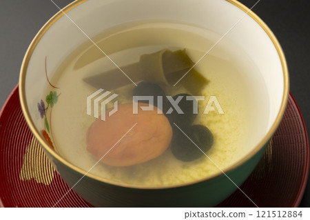 Black bean Fukucha tea - black bean, kelp and pickled plum tea to drink on New Year's Day and other celebratory occasions - to ward off evil spirits - black background 121512884