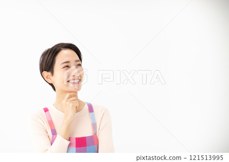 Image of a worried woman wearing an apron (stock photo) Image of a worried woman wearing an apron (stock photo) 121513995
