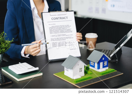 Considering buying a home, investing in real estate. Broker signs a sales agreement. agent, lease agreement, successful 121514307