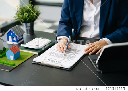 Considering buying a home, investing in real estate. Broker signs a sales agreement. agent, lease agreement, successful Considering buying a home, investing in real estate. Broker signs a sales agreement. agent, lease agreement, successful 121514315