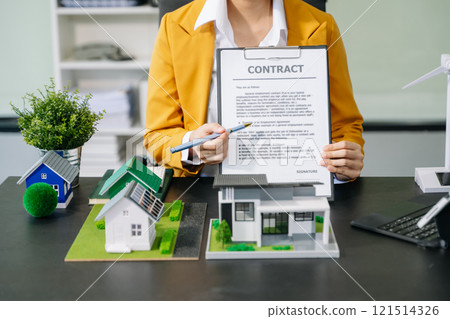 Signing a contract. Client and broker agent, lease agreement, successful deal and Young business sitting at the desk Signing a contract. Client and broker agent, lease agreement, successful deal and Young business sitting at the desk 121514326