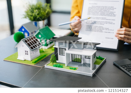 Signing a contract. Client and broker agent, lease agreement, successful deal and Young business sitting at the desk Signing a contract. Client and broker agent, lease agreement, successful deal and Young business sitting at the desk 121514327