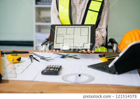 Businessman hand working and laptop with on on architectural project at construction site Businessman hand working and laptop with on on architectural project at construction site 121514378