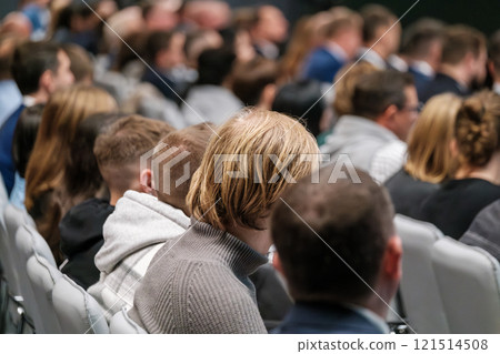 Audience attending a conference or event seated in a lecture room Audience attending a conference or event seated in a lecture room 121514508