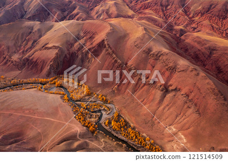 Aerial view of vibrant red mountains and winding river in autumn landscape 121514509