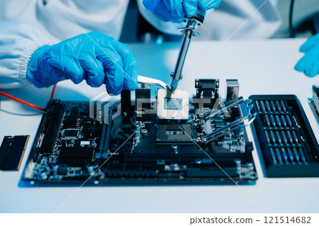 The technician is putting the CPU on the socket of the computer motherboard. electronic engineering electronic The technician is putting the CPU on the socket of the computer motherboard. electronic engineering electronic 121514682