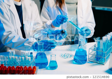 scientists in lab coats conducting research, handling glassware, and working with chemicals scientists in lab coats conducting research, handling glassware, and working with chemicals 121514690