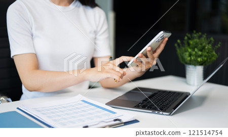 Confident businessman working on laptop,tablet and smartphone at her workplace at office. Confident businessman working on laptop,tablet and smartphone at her workplace at office. 121514754