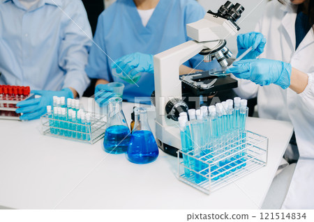 Modern Medical Research Laboratory Portrait of Team Scientists Working, Using Digital Tablet, Analyzing Samples, Talking. for Medicine, Biotechnology Development 121514834