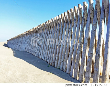 Wooden fence on the sandy beach 121515185