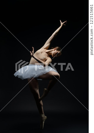 Elegant ballet dancer showcasing grace in a dramatic performance 121515661