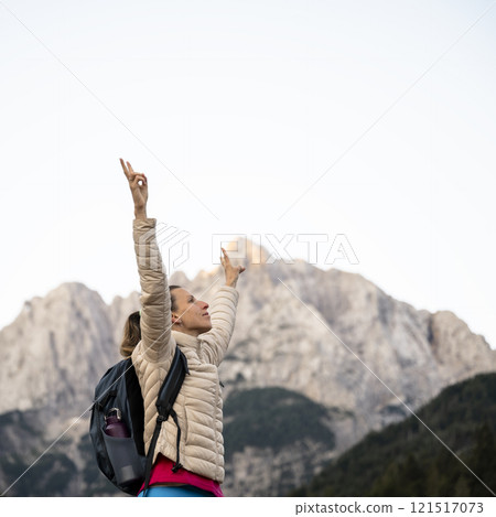 Triumphant in female hiker in nature's embrace Triumphant in female hiker in nature's embrace 121517073