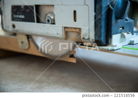 Close Up of Circular Saw Cutting Through Wood with Precision 121518556