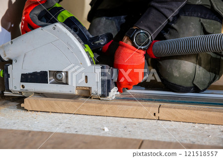 Carpenter Using Circular Saw with Dust Extraction System 121518557
