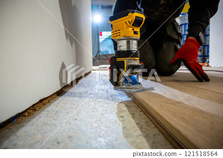Indoor Wood Flooring Installation with Yellow Power Tool Indoor Wood Flooring Installation with Yellow Power Tool 121518564