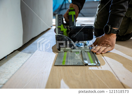 Close Up of Track Saw in Use for Flooring Installation Project 121518573