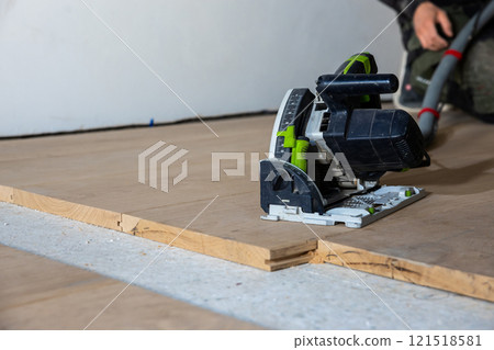 Close Up of Circular Saw on Wooden Floor During Renovation Close Up of Circular Saw on Wooden Floor During Renovation 121518581