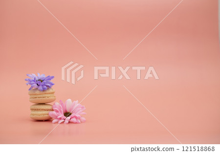 Round beautiful sweets macaroni with flowers on a pink background. Still life with macaroni cakes and different flower. Copy space. Banner Round beautiful sweets macaroni with flowers on a pink background. Still life with macaroni cakes and different flower. Copy space. Banner 121518868