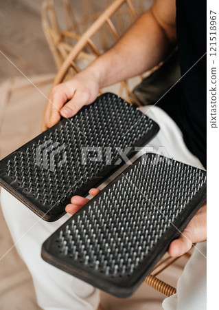 A man holds a Sadhu Board in his hands. Close-up. The concept of a healthy lifestyle. 121518967