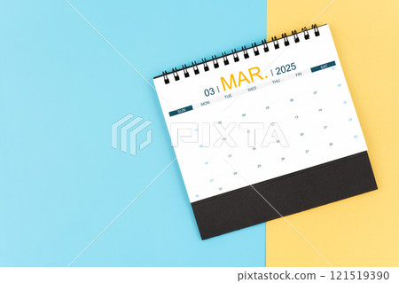 March 2025 desk calendar on blue and yellow, planning for business meeting concept. 121519390