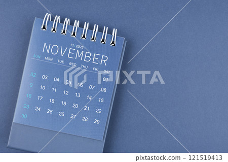 November 2025 calendar on blue color background. Desk calendar for planning. 121519413